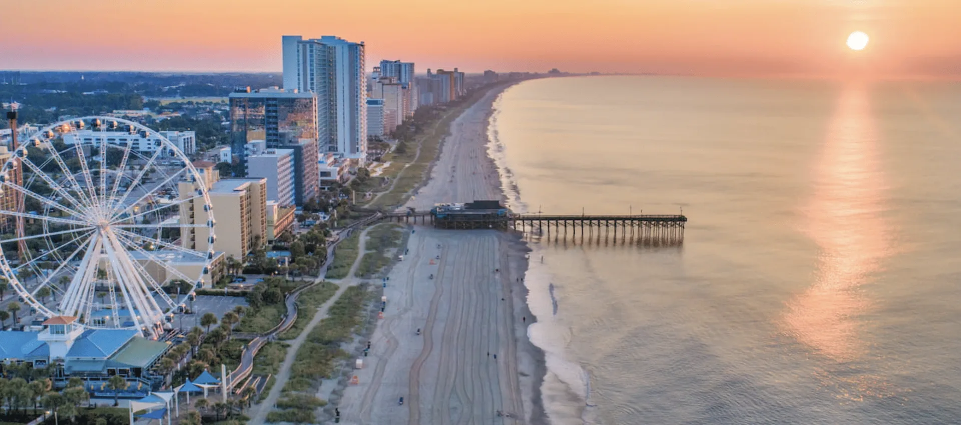 Edificio de ladrillo rojo con columnas blancas y escaleras en la entrada principal.