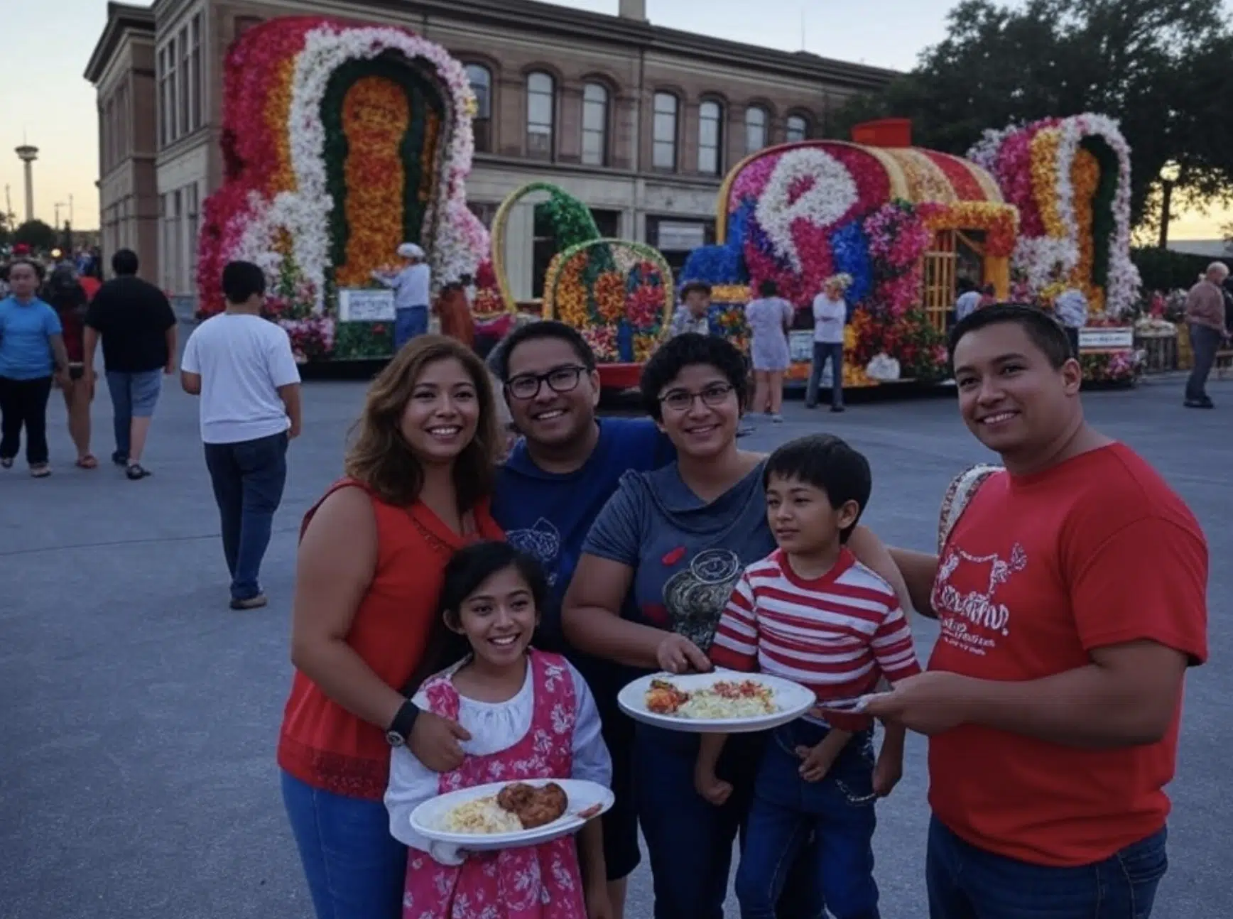 Grupo de seis personas sosteniendo platos de comida en un evento al aire libre con decoraciones florales.
